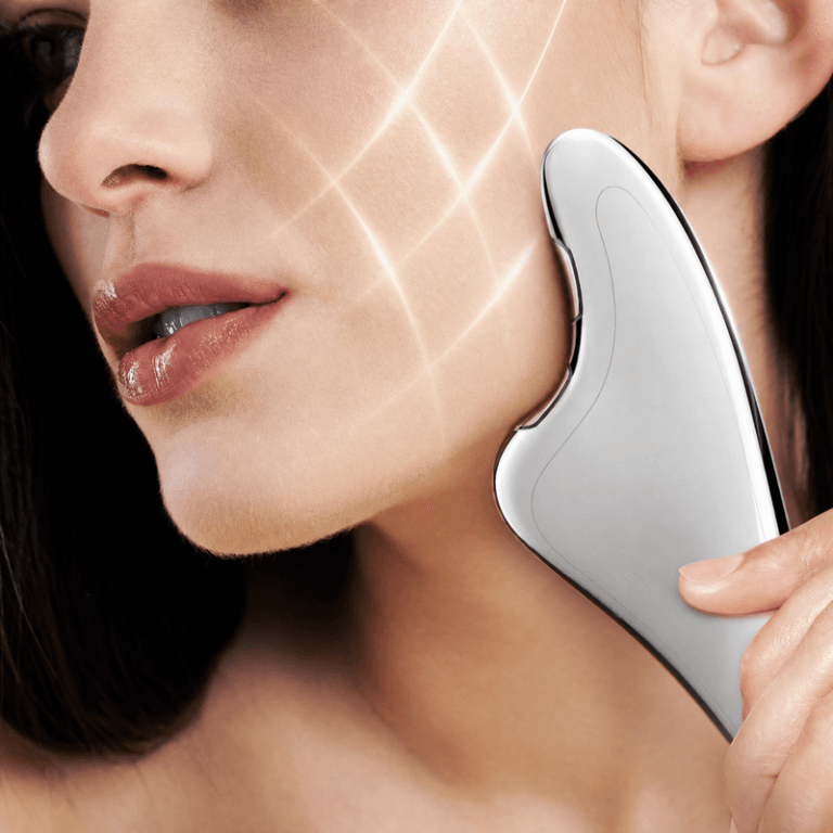 Square close-up of NICEMAY MR-2537 microcurrent gua sha device used on the cheek and jawline.