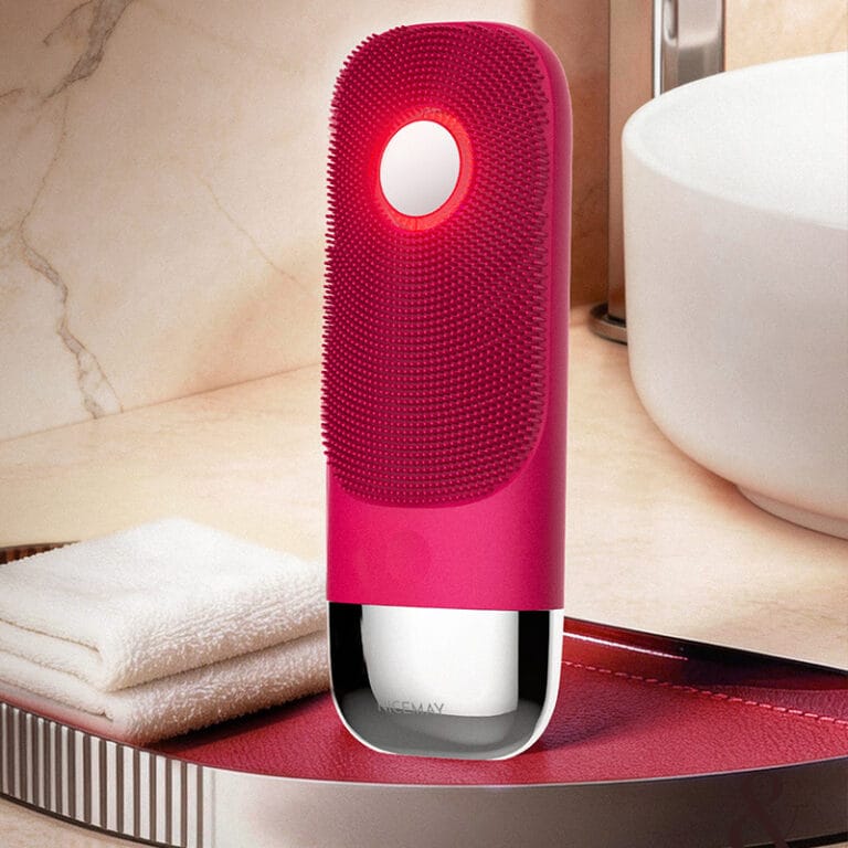 Pink Nicemay MR-2631 silicone facial cleansing brush on a bathroom vanity.