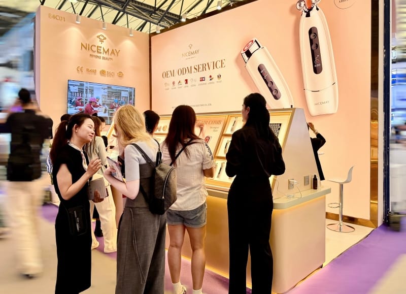 NICEMAY OEM and ODM beauty device booth with visitors viewing product displays at the Shanghai Beauty Expo.