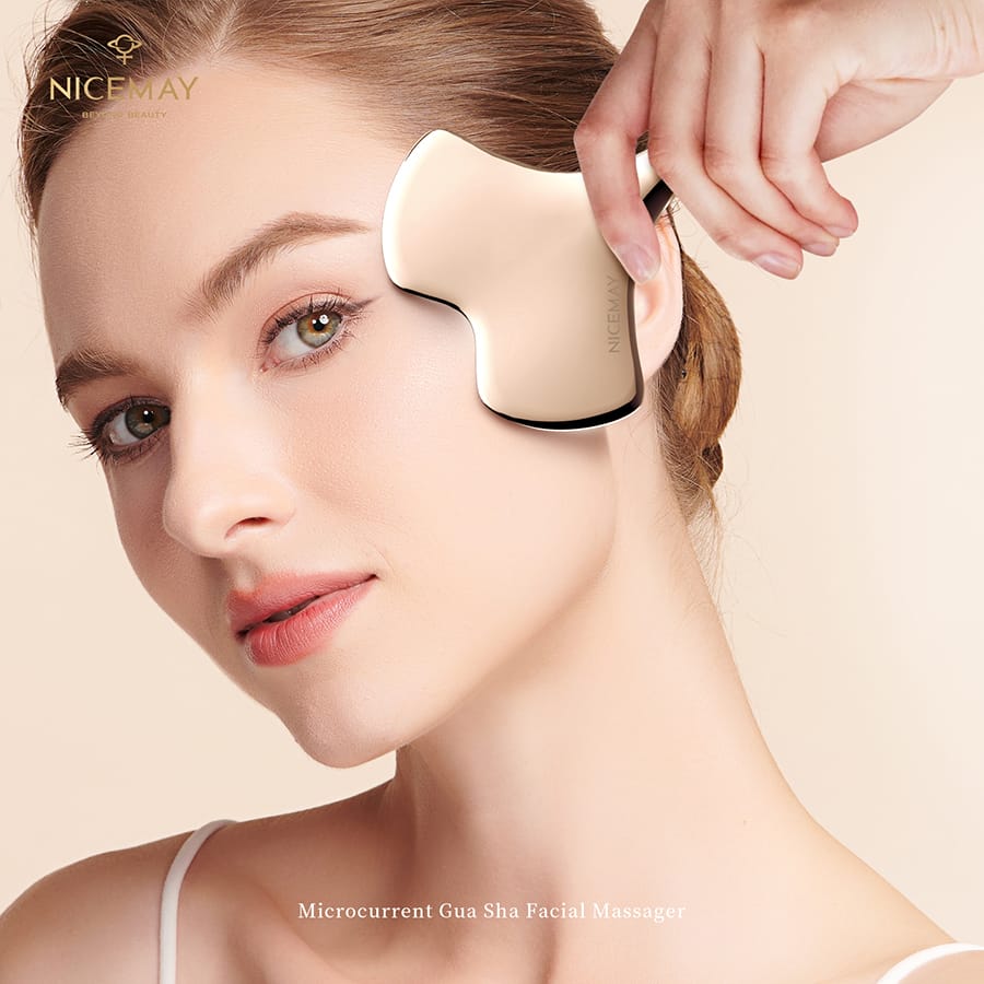 User applying the NICEMAY 2338 microcurrent gua sha massager along the cheek.