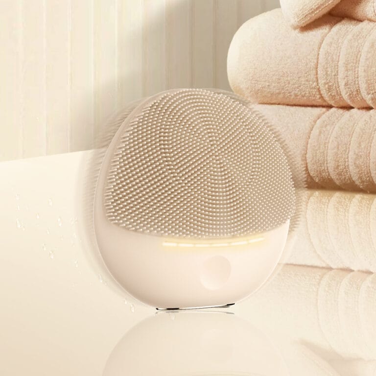 Close-up of the NICEMAY 2369 silicone facial cleansing device with a soft glow.