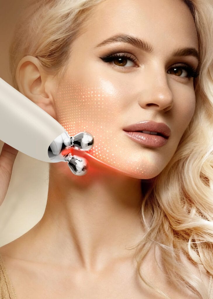 User applying the NICEMAY 2590 facial device with dual roller contacts to the cheek.